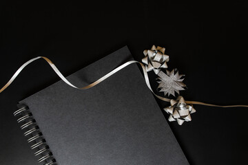 Black notebook mockup scene, with christmas silver items on black background