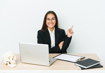Young traumatologist asian woman isolated on white background smiling cheerfully pointing with forefinger away.