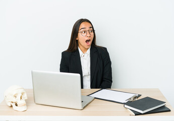 Young traumatologist asian woman isolated on white background being shocked because of something she has seen.