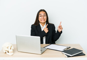 Young traumatologist asian woman isolated on white background shocked pointing with index fingers to a copy space.