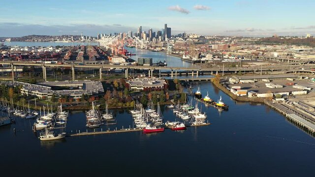 Aerial / drone footage of West Seattle, the West Seattle bridge, docked ships at Harbor Island, Duwamish Waterway, Seattle Harbor terminals, Elliott Bay in Seattle, King County, Washington