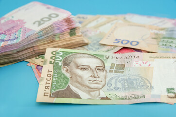 Ukrainian hryvnia on a blue fln. Close-up. Money stack. 500 and 200 hryvnia. Financial concept. Many banknotes