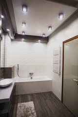 Fototapeta na wymiar Modern bathroom in white and gray tones with mosaic on wide angle view