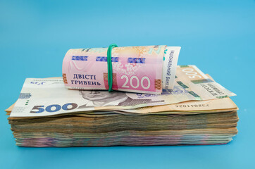 Ukrainian hryvnia on a blue fln. Close-up. Money stack. 500 and 200 hryvnia. Financial concept. Many banknotes