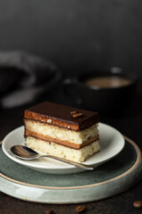 Piece of chocolate and coffee flavor cake on plate 