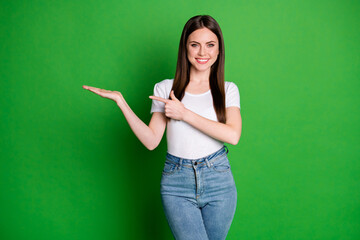 Photo of sweet adorable girl dressed casual outfit pointing one arm finger empty space isolated...