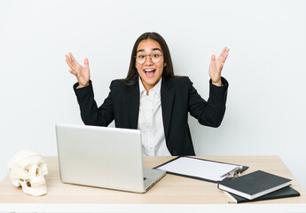Young traumatologist asian woman isolated on white background receiving a pleasant surprise, excited and raising hands.