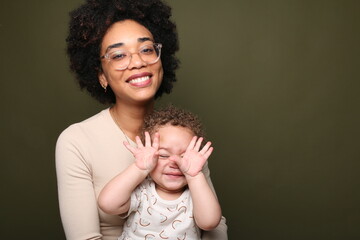 Happy mother and daughter in front of a background