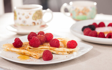 delicious  pancakes with fresh raspberries and honey