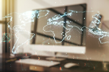 Abstract creative world map on modern laptop background, international trading concept. Multiexposure
