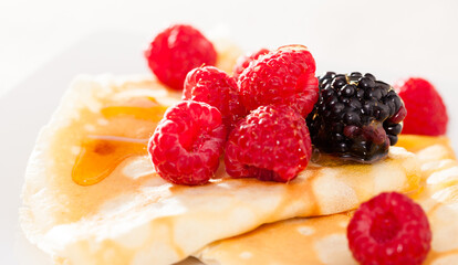 pancakes with raspberries, blackberries and honey
