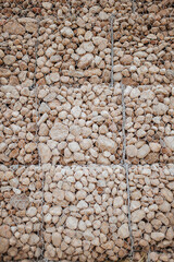 Cobblestone under reinforced mesh - soil reinforcement along the highway