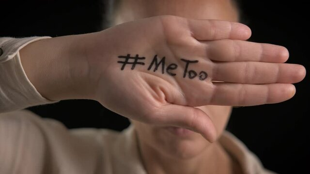 Victim of bulling. A victim of abuse with a slogan metoo on her hand.