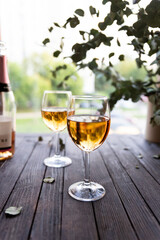 Two glasses of rose wine on wooden table 