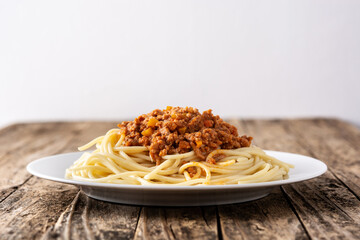 Spaghetti with bolognese sauce on wooden table	