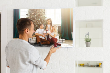 man holds photo canvas at home