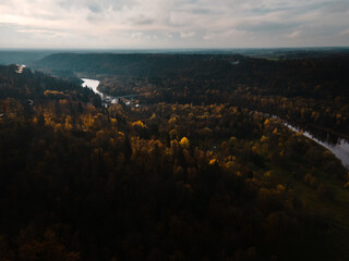 Establishing shot: Epic flight towards beautiful river valley Autumn landscape