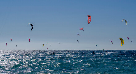 Set of people in the sea practicing kitesurfing in  Tarifa