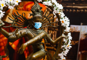 masked stone sculpture of Indian goddess
