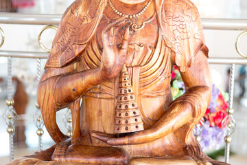 Fototapeta premium Carved wooden buddha hand Holding pagoda buddhist Made Red Wood.