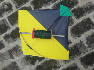 Indian kites and spool used in the very popular sport of kite fighting. These are traditionally used on Makar Sankranti or Independence day