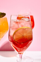 Raspberry spritz cocktail. Pink background