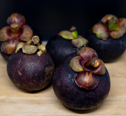 Closeup view of ripe mangosteen on wooden table