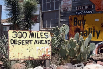 Fototapete Route 66 "300 MILES DESERT AHEAD" sign with cactus in front of abandoned vintage store, Arizona, Route 66  © Ralf