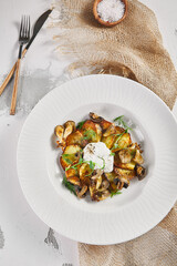 Fried potato with mushrooms and sour cream