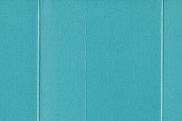 Fototapeta premium A blue vintage rough sheet of carton. Recycled environmentally friendly cardboard paper texture. Simple minimalist papercraft background.