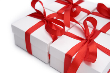 White gift box with red ribbon bow, isolated on white. White box with red ribbon. Gift for Christmas, New Year, Birthday, Valentine's Day. 