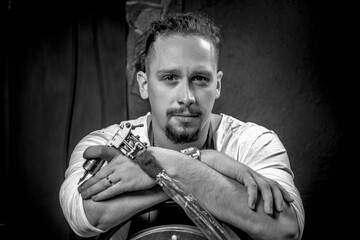 Skin master with a tattoo gun in tattoo studio