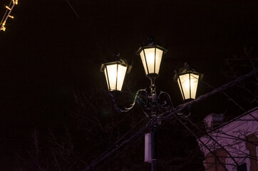 Vintage street lights on festive streets for Christmas and New Years. Night