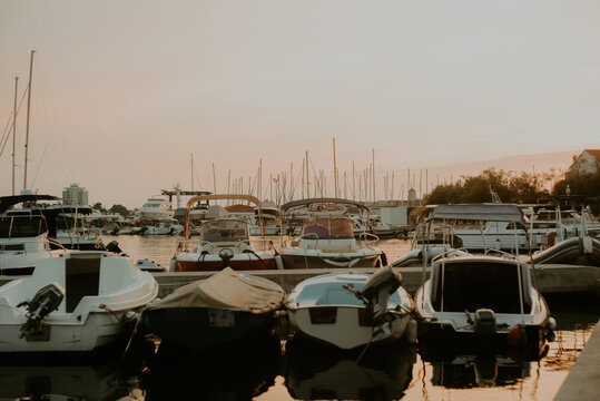 There are many yachts, boats and ships at sea. Marina at sunset.