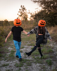 "Clermont, FL / USA - 10-31-2020: Pumpkin heads strolling through the field during Halloween."