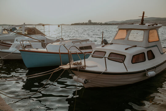 There are many yachts, boats and ships at sea. Marina at sunset.