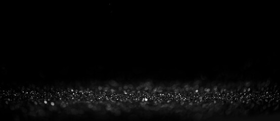 Black friday bokeh background. Elegant dark blur layout design. Silver and black glitter place on table with spotlight. Luxury abstract banner with copyspace. - 389702999