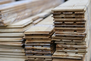 Deck board made of solid wood in a stack. Construction industry. For construction and finishing works. Sale of building materials.