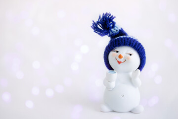 Christmas background. Happy snowman standing in winter christmas landscape with a glass. Merry...