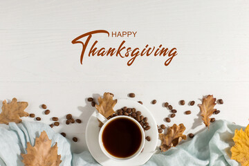 Thanksgiving greetings. Aromatic drink, black coffee and spices, dried leaves on a wooden background, top view. Kaligraphic capital inscription.