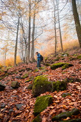 Fototapeta premium woman trekking in beautiful autumn forest