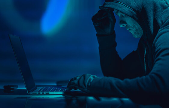 Hacker in Front of His Laptop Computer - Powered by Adobe