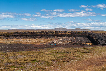 Falkland Islands, UK - December 15, 2008: Wide windswept bare landscape of dry land with a peat...