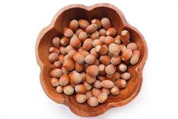 Bowl with hazelnuts. Healthy snack nuts. Top view of bowl with hazelnuts on isolated background. Healthy food concept