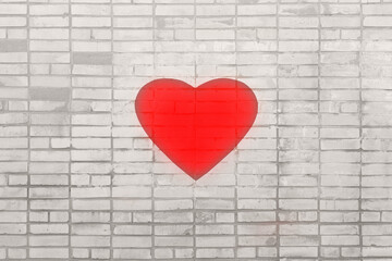 Big red heart on a gray brick wall. The concept of health and the struggle of doctors for the lives of patients