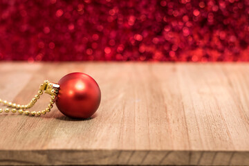 Single red ornament on wooden board red glitter for holiday sale, christmas background copy space