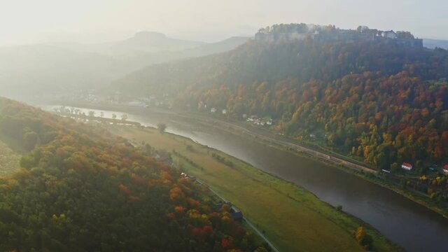 aerial flight over colorful trees and river Elbe in Saxon Switzerland, Germany