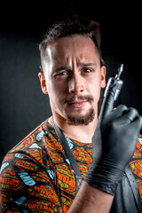 Tattoo specialist looking at the camera in tattoo studio