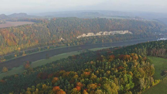 aerial flight over colorful trees and river Elbe in Saxon Switzerland, Germany
