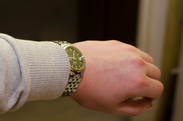 The man looks at the clock